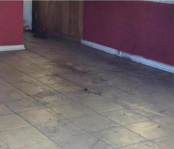 soot on tile floor and walls of vacant house
