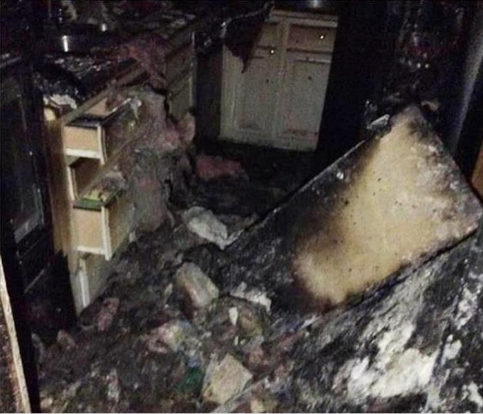 badly burned and charred building materials and contents in a kitchen