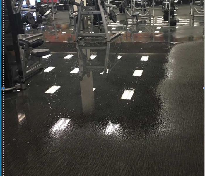 pooling water in fitness center, lots of equipment