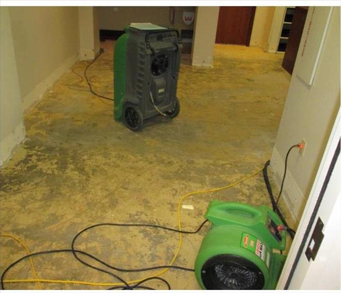 stripped floor to concrete pad, devices shown for drying
