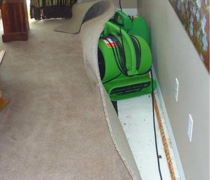 two air movers drying floated carpet