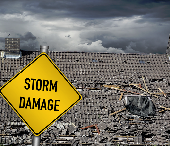a sign in front of a house that says storm damage